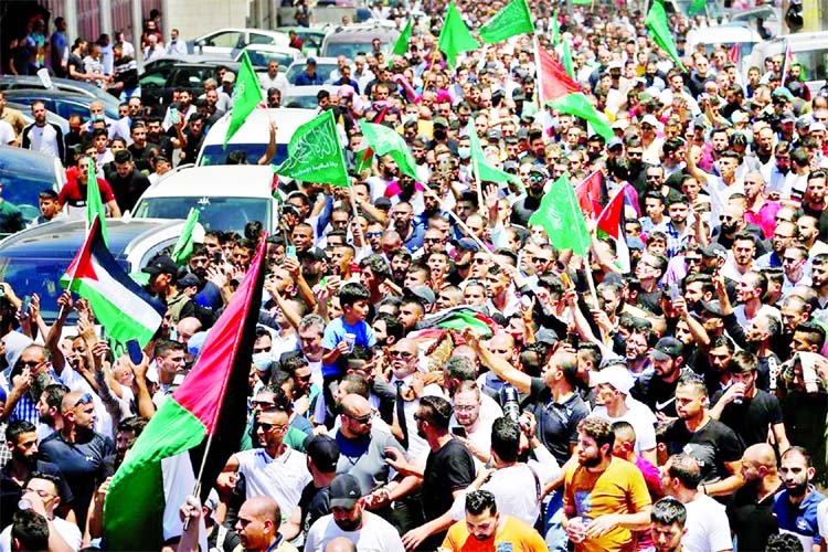 People attend the funeral of Palestinian critic Nizar Banat, who died after being arrested by Palestinians Authority's security forces, in Hebron in the Israeli-occupied West Bank on Friday.