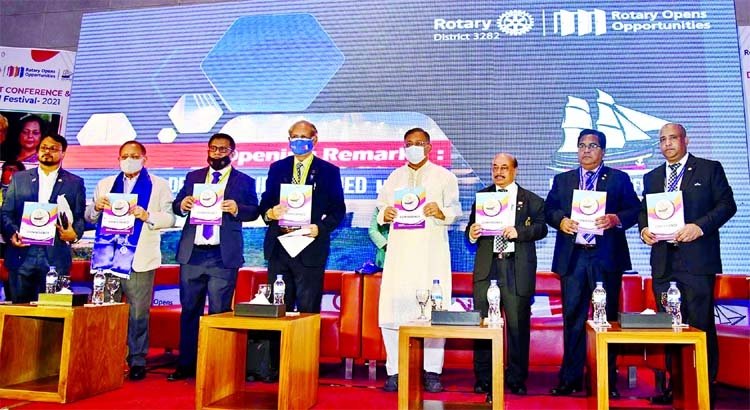 Information and Broadcasting Minister Dr. Hasan Mahmud, among others, holds the copies of souvenir on its cover unwrapping ceremony at Radisson Blu Hotel in Chattogram on Friday on the occasion of Rotary District Conference-2021.