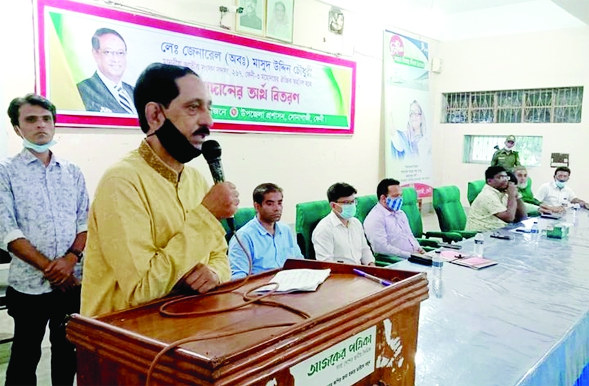 Former Deputy Secretary of the Ministry of Education Prof Saif Uddin Ahmed Chowdhury Harun as chief guest speaks at a cash aid distribution ceremony held at the Sonagazi Upazila Parishad auditorium on Thursday with Upazila Nirbahi Officer AM Zahirul Hayat