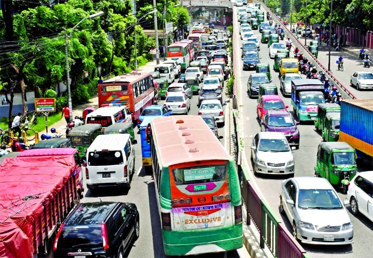 Hundreds of motor vehicles get clogged at Satrasta intersection of Tejgaon area in the capital on Sunday ahead of countrywide lockdown to be imposed from Monday.