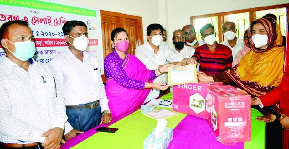 Gabtoli, Bogura Upazila Nirbahi Officer Mst. Rownak Jahan distributes sewing machines, certificates and cash aid among 46 trainees under LGSP-3 project implemented by Nepaltoli union of the upazila on Monday.