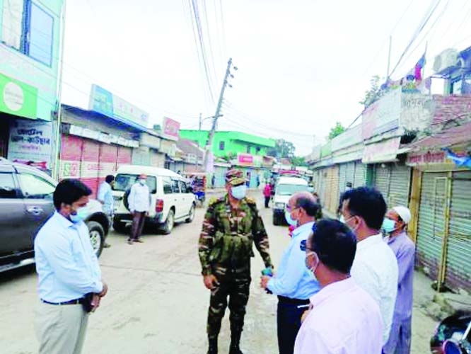 Deputy Commissioner of Kishoreganj district Mohamad Shamim Alam is seen with army personnel in a mobile court at Akrampur in Kishoreganj town to maintain strict lockdown declared countywide on Thursday.