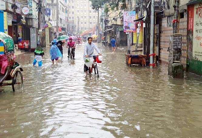 Passengers and also pedestrians wade through the water-logging street due to absence of proper drainage system. The snap was taken from the city's Tikatuli Kamrun Nesa Government Girls' High School on Friday.