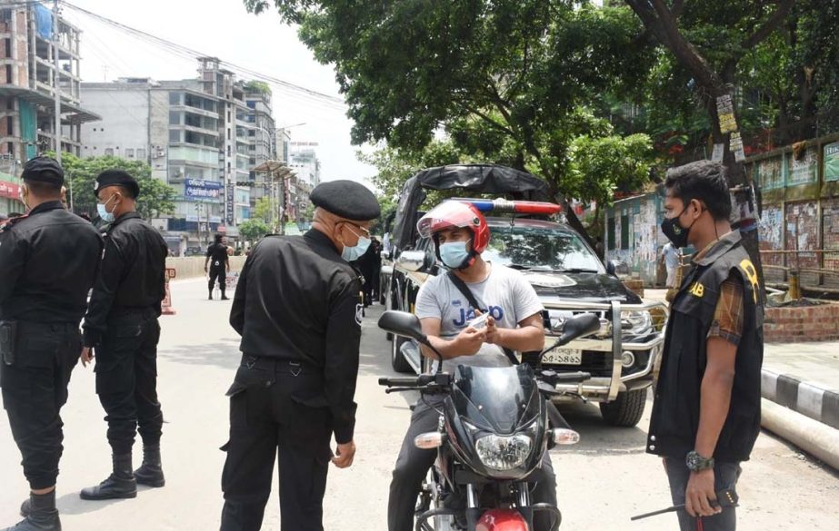 RAB members check the identity cards of the commoners setting check posts on the street. The snap was taken from the city's Mirpur area on Saturday.