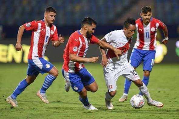 Peru's Christian Cueva (right) and Paraguay's Alberto Espinola vie for the ball during their Conmebol 2021 Copa America football tournament quarter-final match at the Olympic Stadium in Goiania, Brazil on Friday.