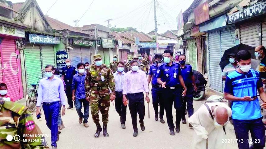 Army and police patrol in Bhangura upazila town led by the Nirbahi Magistrate, UNO Syed Asrafujjaman on the third day of nationwide lockdown. The Photo was taken from Bhangura Bazar on Saturday.