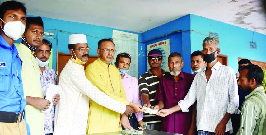 Chairman of the Gabtoli Baliadighi Union under Bogura district Mahbubur Rahman Mahbub distributes Tk. 500 each given by the Prime Minister Sheikh Hasina among 250 jobless poor people of the Union on Saturday.