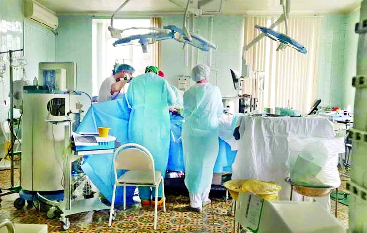 Doctors and nurses perform a surgery at a local clinic of cardiac surgery in the city of Blagoveshchensk, Russia.