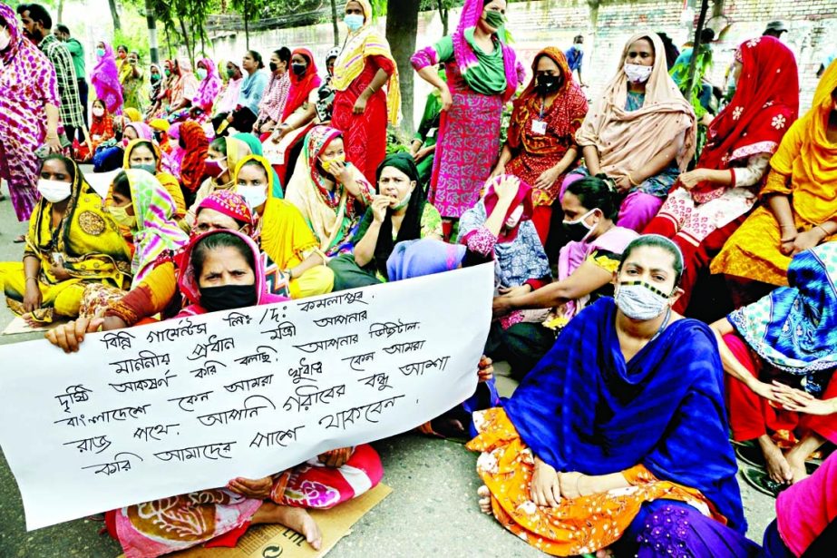 Workers of 'Binny Garments' in a sit-in programme in the capital's Kamalapur area on Saturday make an appeal to the Prime Minister to realize their outstanding salaries as financial hardship threatens to their life and livelihood during this ongoing na