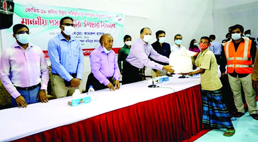 Chittagong Divisional Commissioner Kamrul Hasan hands over PM's gifts to the owners and workers of decorators and 300 poor families of Chattogarm district in a formal ceremony held at the city gymnasium adjacent to MA Aziz Stadium on Sunday.