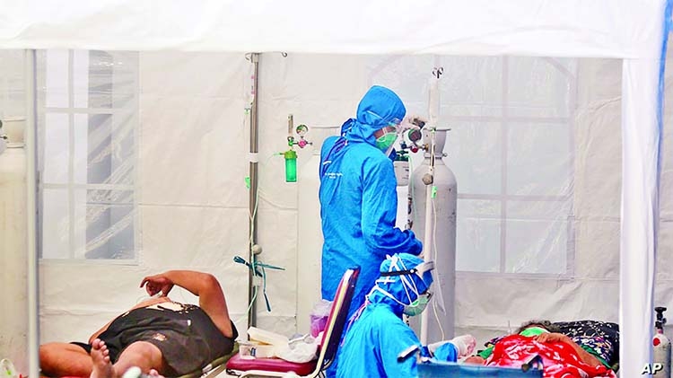 Medical workers treat patients inside an emergency tent erected to accommodate a surge in Covid-19 cases, at Dr. Sardjito General Hospital in Yogyakarta, Indonesia on Sunday.