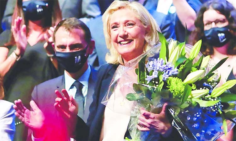 Marine Le Pen, chief of far-right French political party, holds a bunch of flowers to a standing ovation following her closing speech at the end of the party's congress in southern France on Sunday.