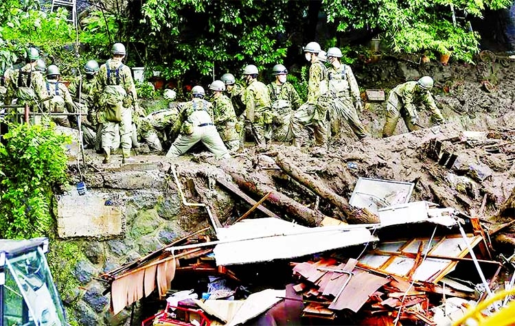 Members of Japanese Self-Defence Forces conduct rescue and search operation at a mudslide site caused by heavy rain at Izusan district in Atami, west of Tokyo, Japan on Monday.