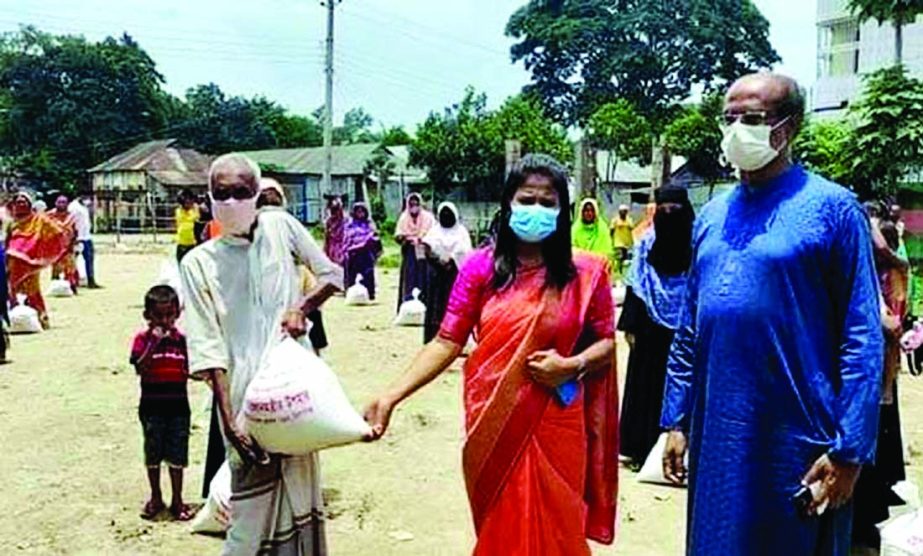 Bhairab UNO Lubna Farzana distributes food aid provided by the Prime Minister as gifts for survival of 700 poor men living in the area amid nationwide lockdown in a formal event held at Shimulkandhi Union Parishad premises on Monday.