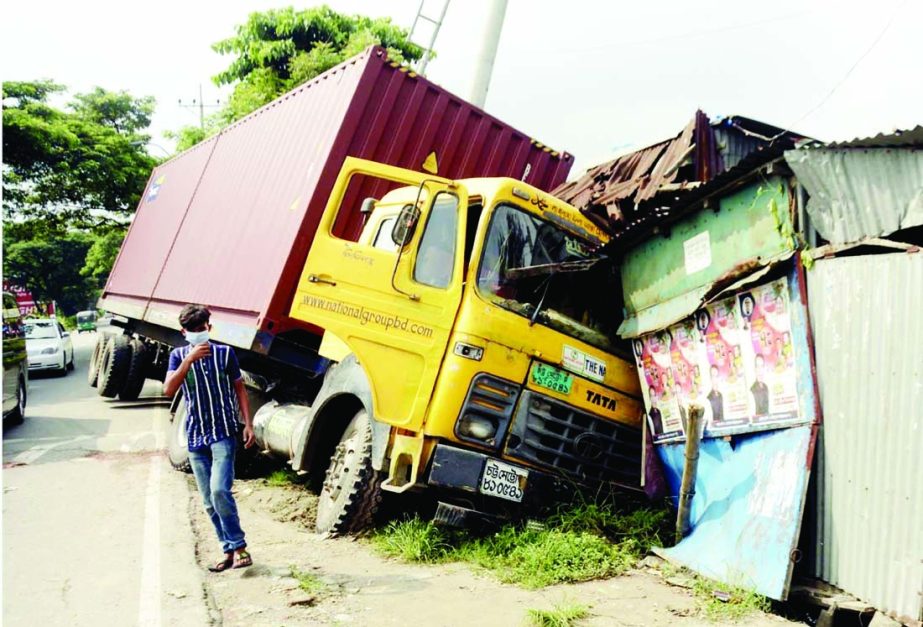 A goods laden covered van enters into a makeshift shop for driving recklessly. The snap was taken from Ashulia Model Town area on Tuesday.