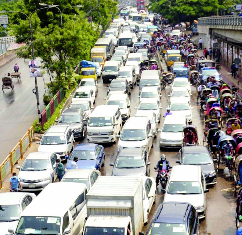 Hundreds of private cars along with rickshaws are seen at Rampura area in the capital on Tuesday creating traffic congestion despite strict lockdown.