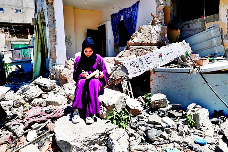 Artist Saja Moussa draws on broken tiles from her family's damaged house in Rafah refugee camp, southern Gaza Strip.