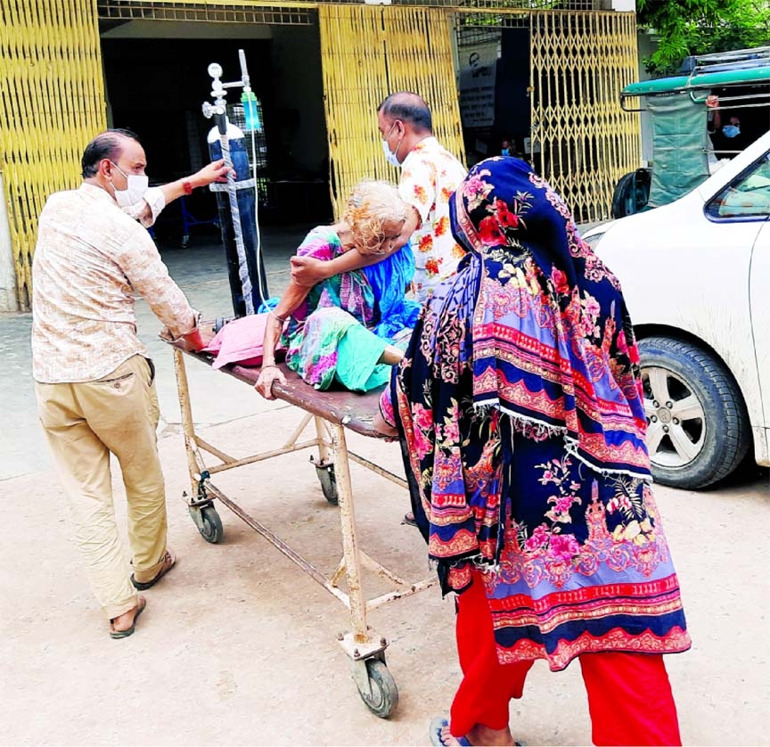 A Covid patient from remote Putia upazila is being taken to Rajshahi Medical College Hospital on Wednesday amid surge in coronavirus cases across the country.