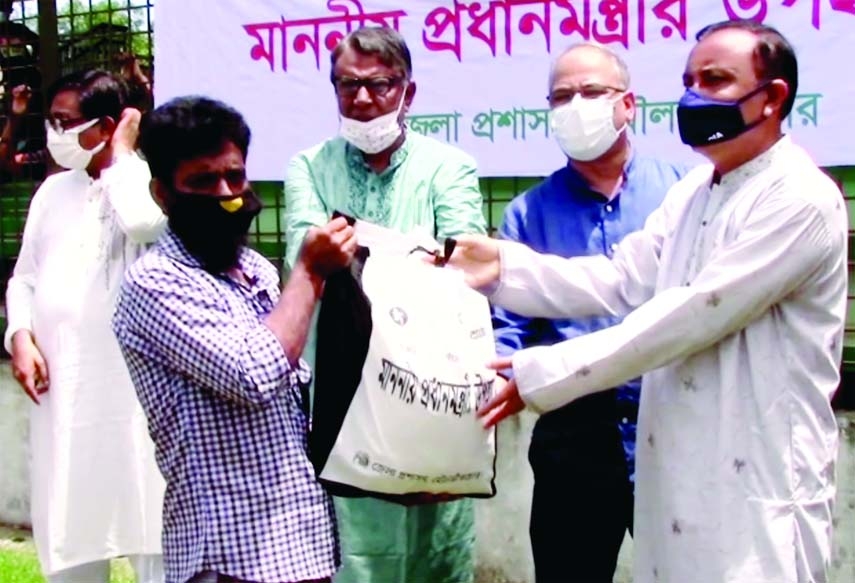 Nesar Ahmed, MP from Moulvibazar-3 distributes relief goods among jobless 500 people of the district provided by the government for the poor to survive in the ongoing lockdown in a formal ceremony held at Moulvibzar stadium on Thursday.