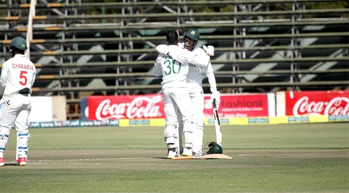 Bangladesh batsman Mahmudullah (left) celebrates with team-mate Taskin Ahmed after scoring a century on the second day of their lone Test against Zimbabwe at Harare Sports Club Groud on Thursday.