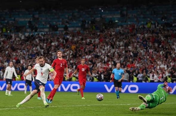 England's forward Harry Kane (left) shoots and scores a goal during the UEFA EURO 2020 semi-final football match between England and Denmark at Wembley Stadium in London on Wednesday.