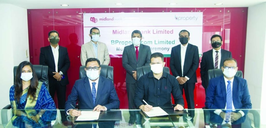 Syed Ashiqur Rahman, General Manager, Bproperty and Md. Ridwanul Hoque, Head of Retail Distribution Division of Midland Bank Limited, signing an agreement on behalf of their respective organizations at the bank's head office in the capital recently. Unde