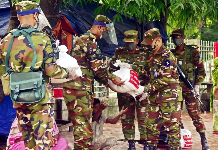 Army members distribute food items among the destitute during lockdown in front of Engineers Institute in the city on Thursday.