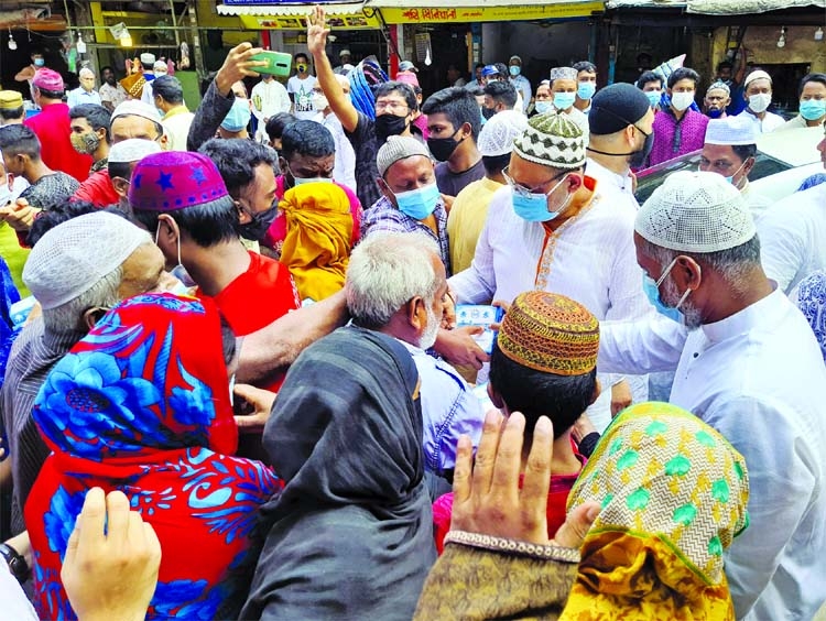 President of Dhaka Mahanagar Dakshin Awami League Abu Ahmed Mannafi distributes food among the destitute after Jum'a prayers at a programme organised by the devotees of Tikatuli Jame Mashjid in the city. General Secretary of the mashjid and also Councill