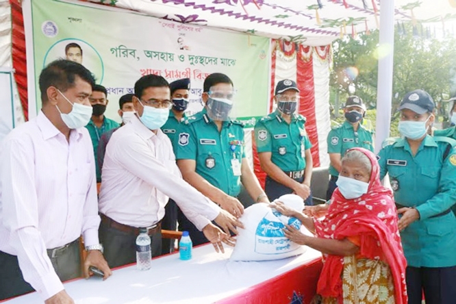 Commissioner of Rajshahi Metropolitan Police Abu Kalam Siddique distributes relief materials among the distressed people including people with special needs and transgenders at Guljarbag Eidgah Math on Thursday.