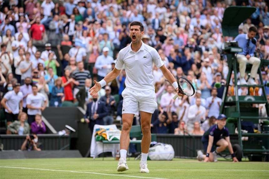 Serbia's Novak Djokovic celebrates after winning against Canada's Denis Shapovalov in their men's singles semi-final match of the 2021 Wimbledon Championships at The All England Tennis Club in Wimbledon, southwest London on Friday.