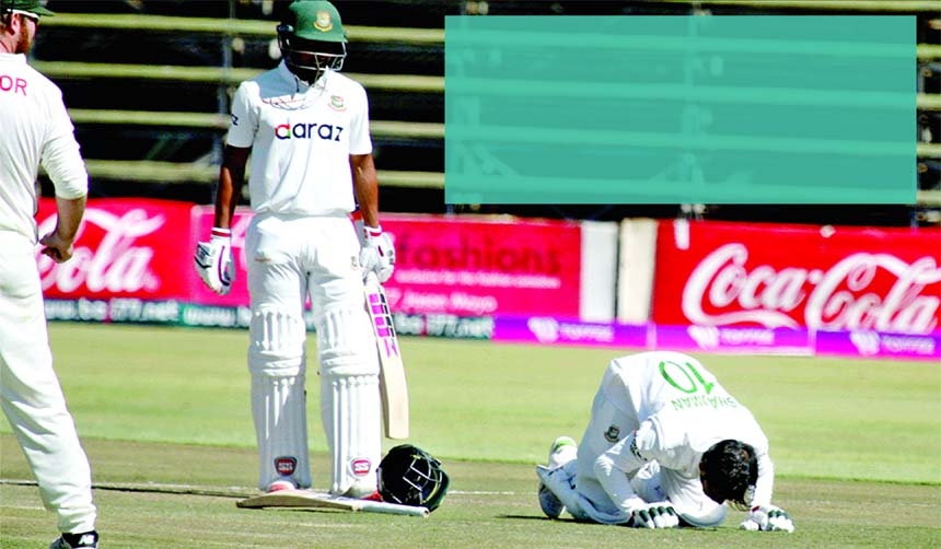Shadman Islam (right) of Bangladesh, celebrates after reaching his maiden Test century against Zimbabwe on the fourth day of the lone Test match at Harare Sports Club Ground in Harare on Saturday.