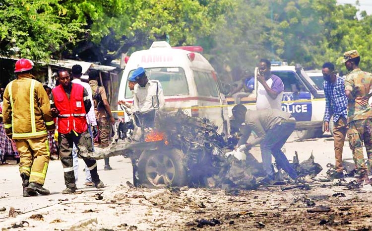 Rescuers, security and paramedics are seen at the scene of a car explosion near Banadir hospital in Mogadishu, Somalia on Saturday.