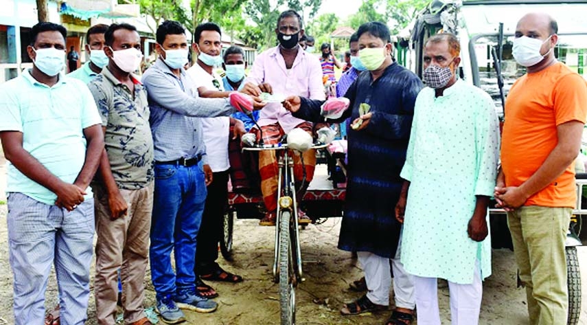 Chairman of Bogura Rameshwarpur Union Md. Sekendar Ali on Sunday distributes cash aid among 50 auto-van and rickshaw drivers and owners as provided by the Prime Minister Sheikh Hasina to survive in this nationwide lockdown to contain corona pandemic.