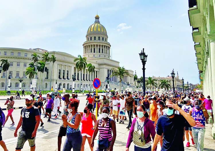 People gather during protests against and in support of the government, amidst the coronavirus outbreak, outside the Capitol building, in Havana, Cuba.