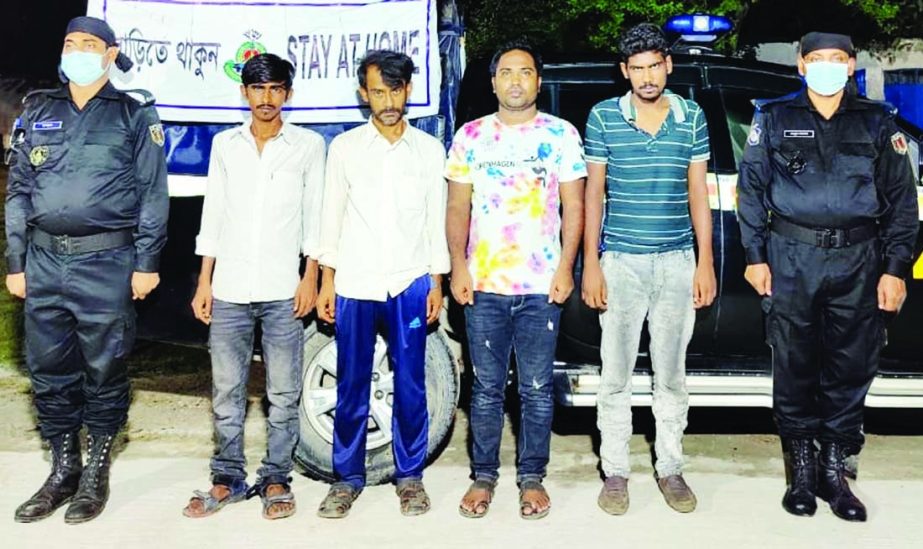 RAB-4 detains 4 members of a gang of robbers with country made weapons and private car conducting raid at Bypile area in Ashulia on Monday.