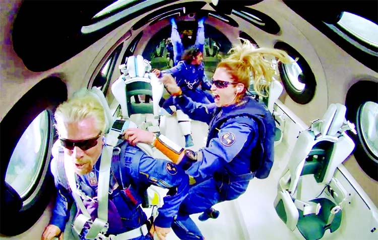 Billionaire Richard Branson makes a statement as crew members Beth Moses and Sirisha Bandla float in zero gravity on board Virgin Galactic's passenger rocket plane VSS Unity after reaching the edge of space on Sunday.