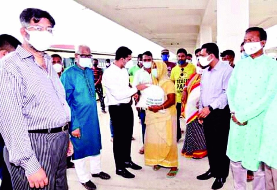 Md. Moniruzzaman Talukder, Deputy Commissioner of Khulna distributes Prime Minister's food assistance to the transport workers and ultra poor people at Khulna Railway Station Square on Monday.