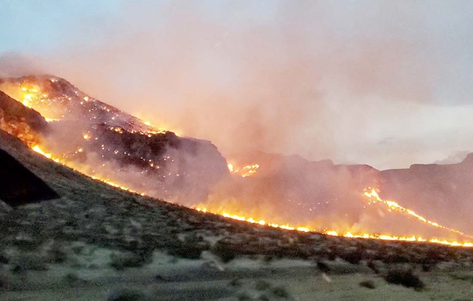 Flames are seen on the side of highway after a bushfire broke out, near St George, Arizona, US on Monday.