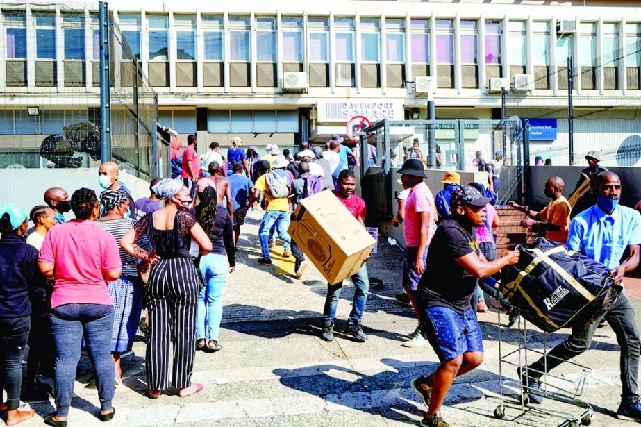 Looters make off with goods from a store in Durban amid spiralling unrest in South Africa triggered by the jailing of former president Zuma.