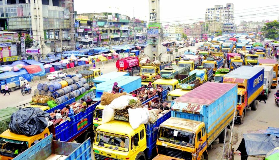 Hundreds of vehicles get stuck in a long tailback on Dhaka-Chattogram Highway on Tuesday as goods and cattle laden trucks enter the capital.
