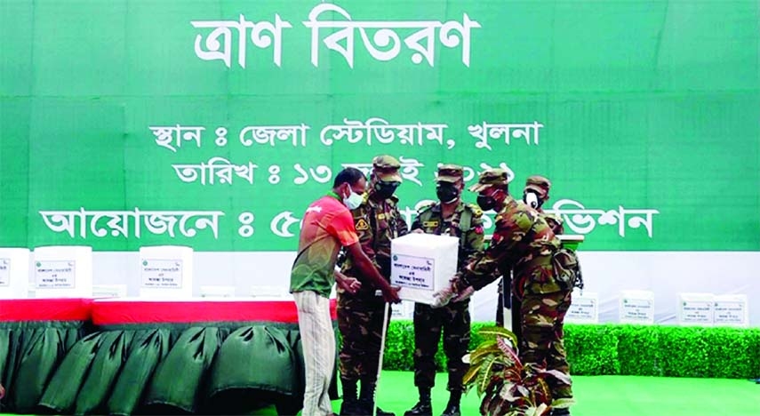 Army Chief General SM Shafiuddin giving foodstuff to the ultra poor people at Khulna Stadium square on Tuesday.