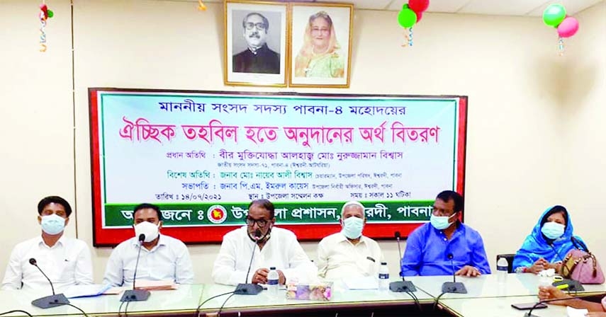 Nuruzzaman Biswas, MP from Pabna-4 speaks in a program to distribute cash among the poor at the conference room of the Iswardi Upazila Parishad with its UNO PM Imrul Kayes in the chair.