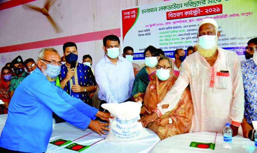 Asib Ahsan, Rangpur Deputy Commissioner, hands over food aid as Eid gifts to 1120 helpless employees who lost their jobs due to the closure of shops in the lockdown at an event organized by Rangpur District and Metropolitan Committee of the Bangladesh Sho