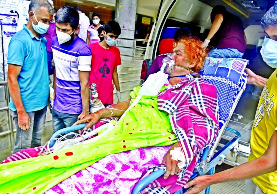 Relatives of a Covid patient with breathing problem taking him from an ambulance for treatment to the Dhaka Medical College Hospital on Thursday amidst the spread of coronavirus disease in Bangladesh.
