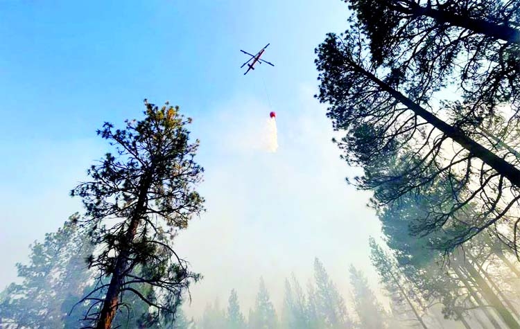 An aircraft flies over the Bootleg Fire as it rages in Klamath and Lake Counties, in Oregon, U.S.