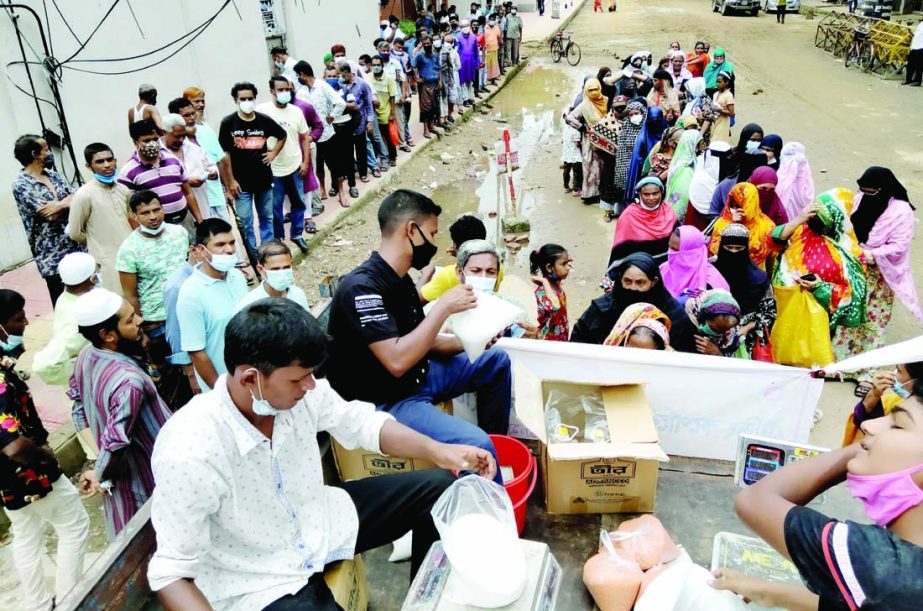 Commuters in a long queue to buy essential commodities from TCB truck cell. The snap was taken from in front of the Secretariat on Saturday.