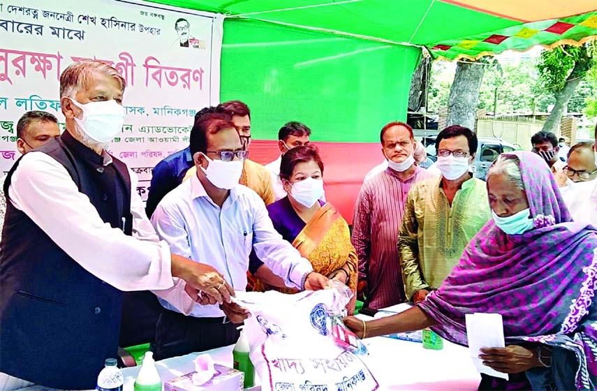Deputy Commissioner of Manikganj Muhammad Abdul Latif distributes food and healthcare items among 2,000 unemployed families in a relief distribution program organized by the district council on its premises with the Council Chairman Golam Mohiuddin in the