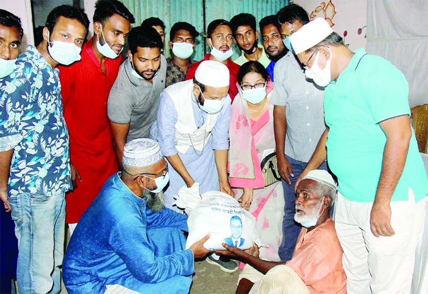 Former MP and member of the Advisory Committee of BNP Chairperson Khaleda Zia, Md. Helaluzzaman Talukder distributes foodstuff among the distressed people of Bogura to survive in the corona pandemic organized by District BNP on Friday.