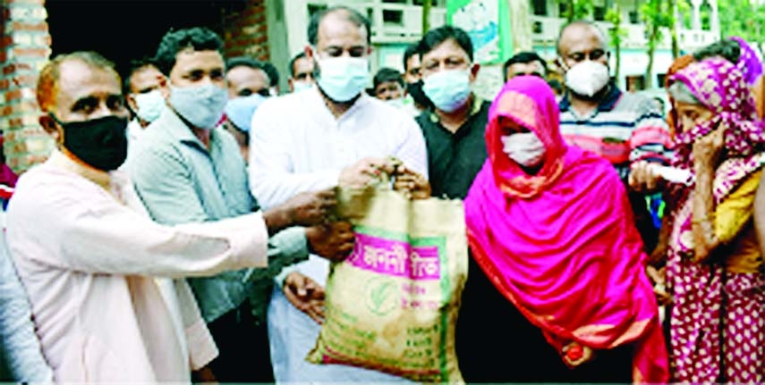 Chairman of Bogura Gabtoli Upazila Rafi Newaz Khan inaugurates the distribution ceremony of 10 kg rice per head allotted by the Disaster and Relief Ministry on the occasion of Eid-ul-Azha amid corona pandemic at Rameshwar union of the upazila on Sunday.