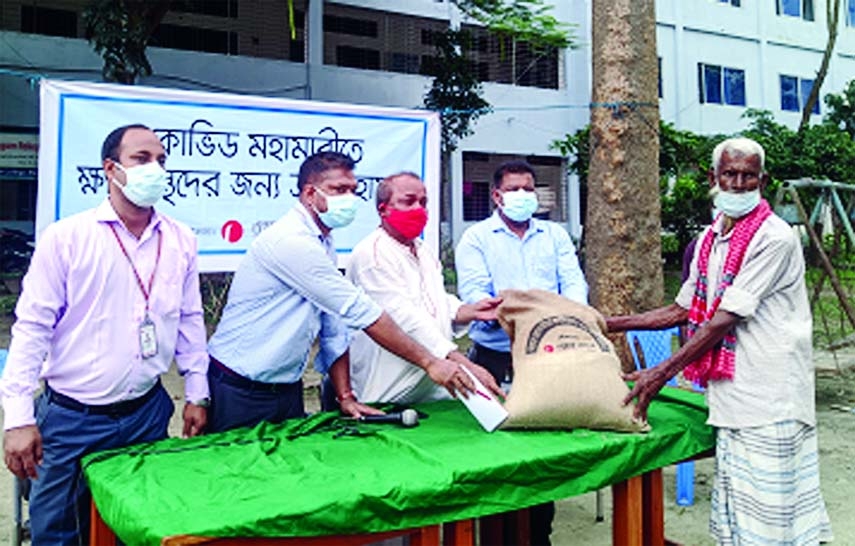 Aktaruzzaman, Manager of One Bank Ltd distributes relief among 700 people in Rangpur at a function held at Siddique Memorial School and College ground on Sunday in presence of Maidul Islam, Principal Officer of the Bank, Ferdous Alam Mukul, Chairman of th